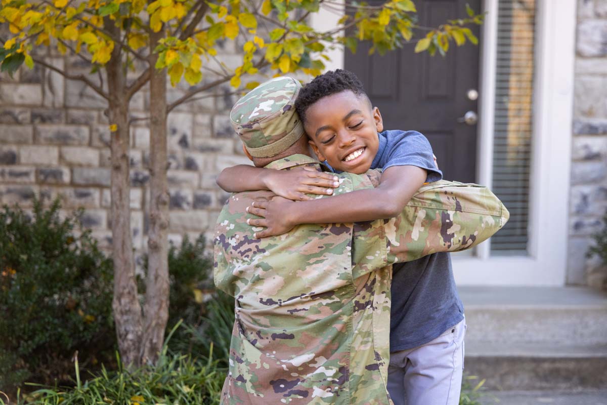 military father hugs son