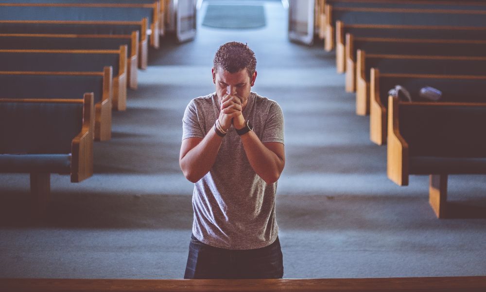 A soldier preparing for chaplaincy training by praying in a church