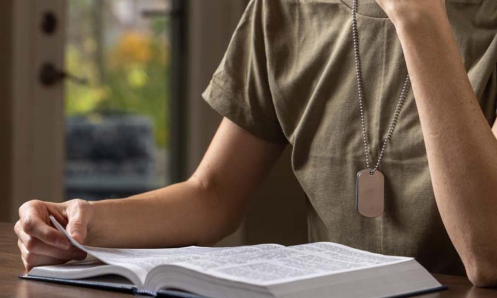 A Military member reading the bible to deal with moral injury and spiritual care