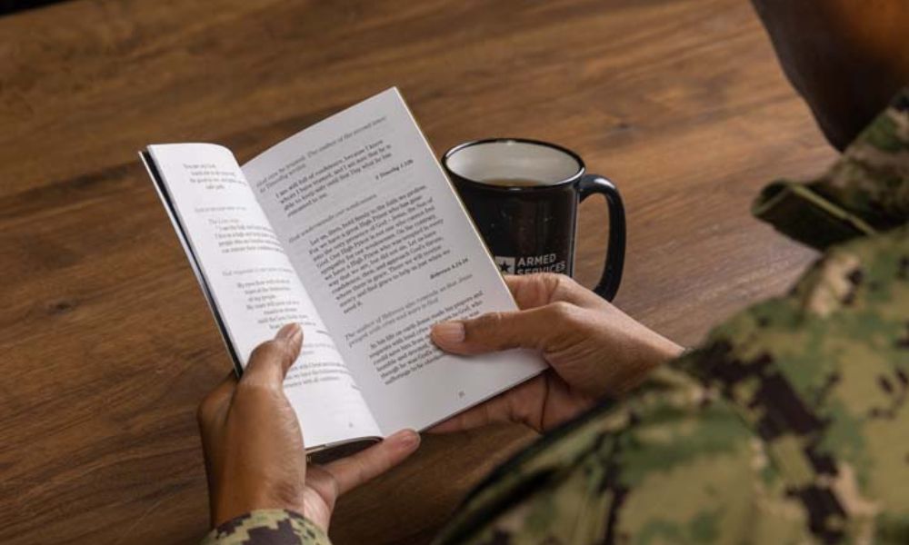 A service member reading bible verses about transformation
