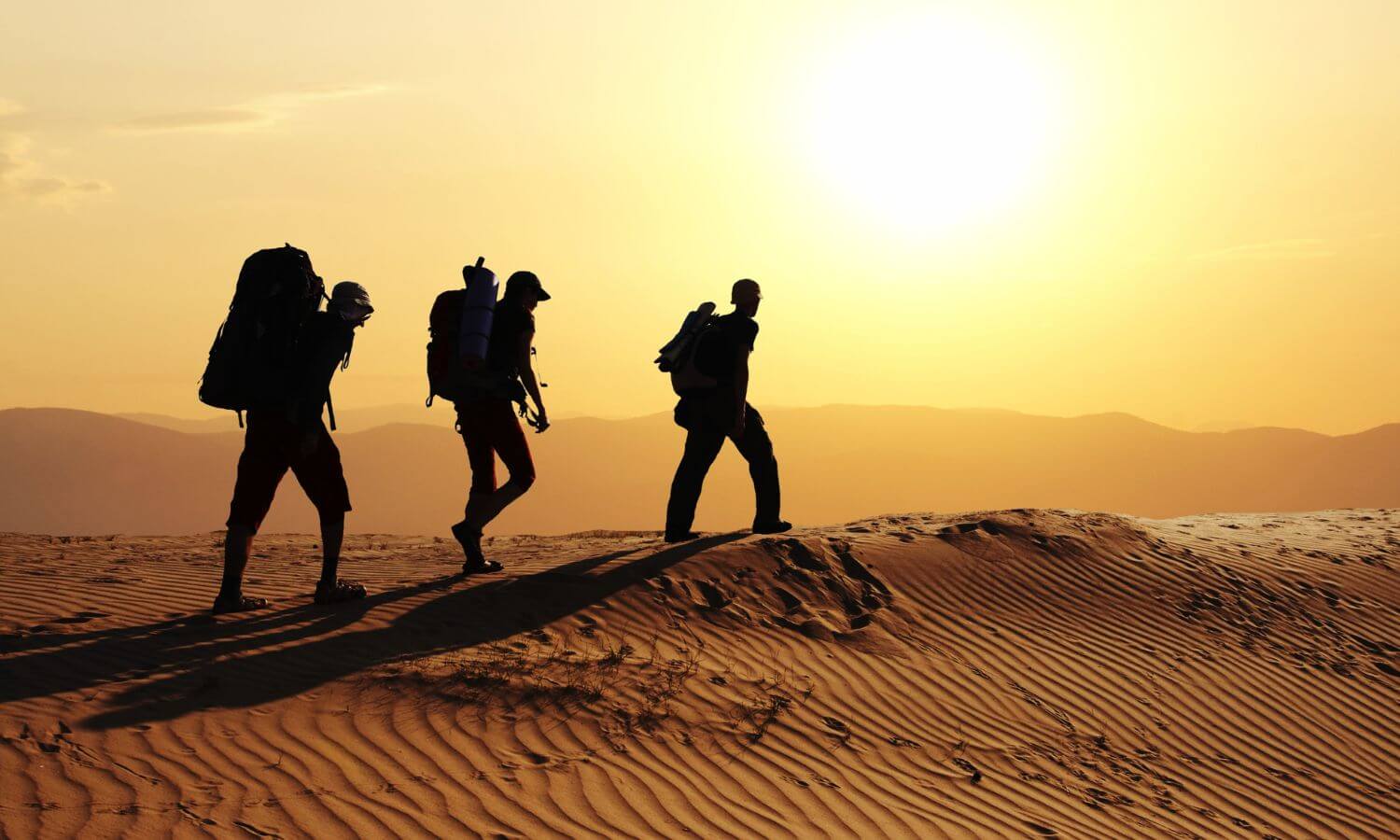 A military family hiking in a desert